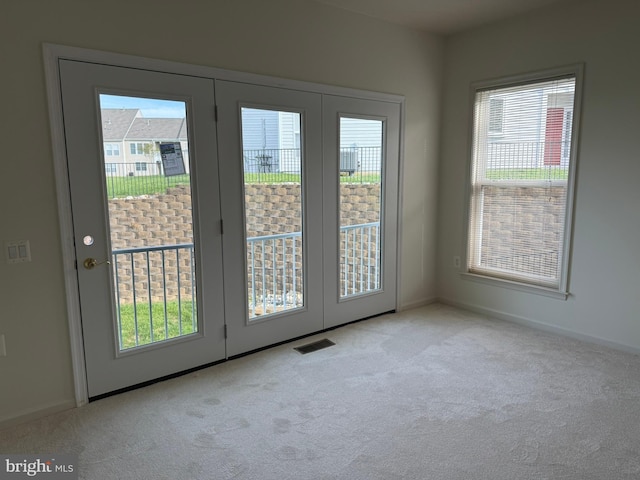 entryway featuring carpet, visible vents, and baseboards