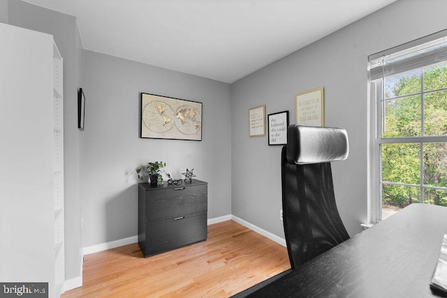 office area featuring light wood finished floors and baseboards