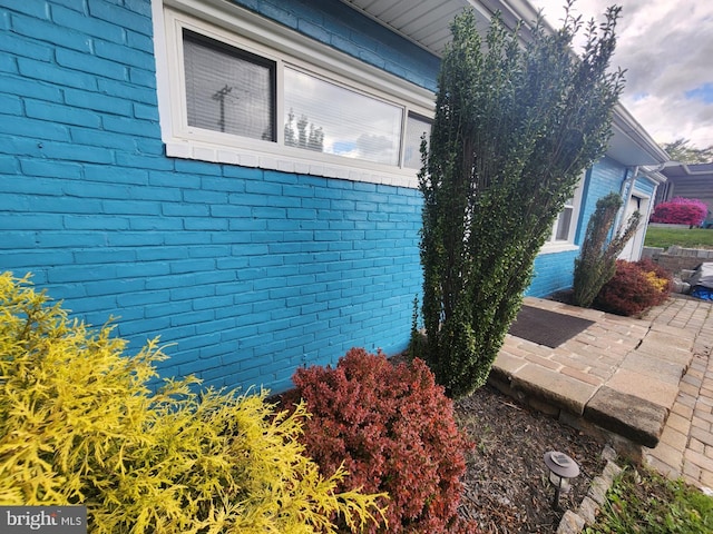 view of side of home with brick siding