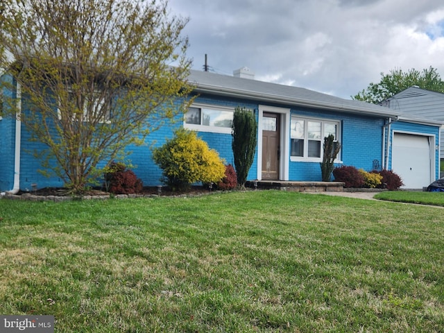 single story home featuring a front yard, brick siding, and a garage