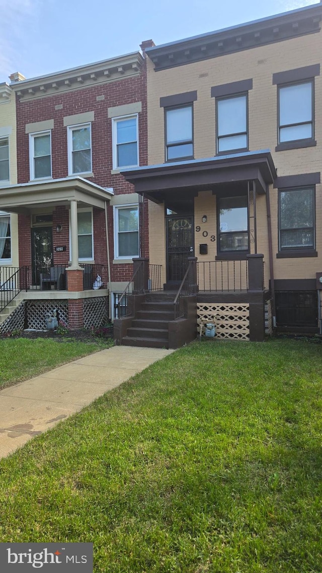 903 K St NE, Washington, DC 20002 - townhome / multi-family property featuring covered porch, brick siding, and a front lawn