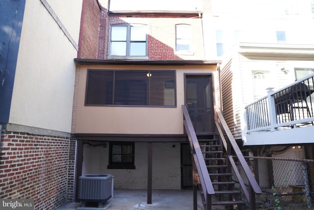 903 K St NE, Washington, DC 20002 - back of house with a patio, stucco siding, stairway, central AC unit, and brick siding