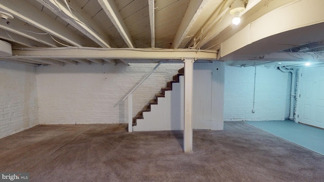 903 K St NE, Washington, DC 20002 - basement featuring carpet flooring, stairway, and brick wall