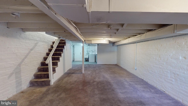 903 K St NE, Washington, DC 20002 - unfinished below grade area with washer / clothes dryer, stairs, carpet floors, and brick wall