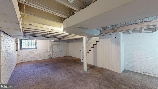 903 K St NE, Washington, DC 20002 - below grade area featuring visible vents, brick wall, carpet flooring, and stairs