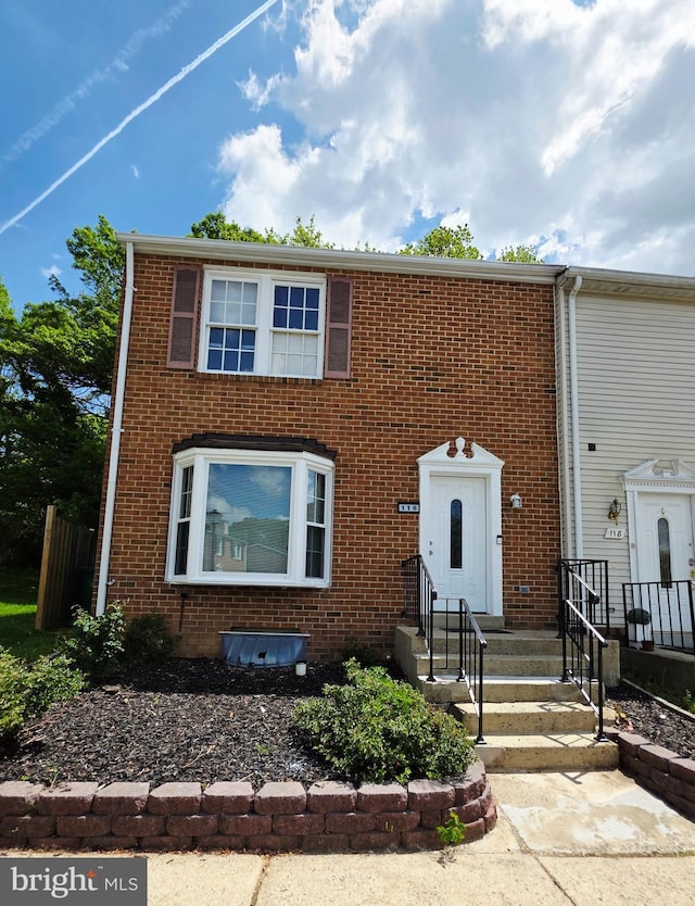 townhome / multi-family property with brick siding