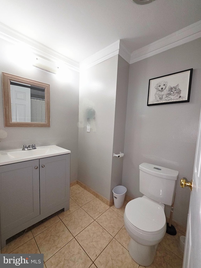full bathroom with vanity, baseboards, tile patterned floors, toilet, and ornamental molding