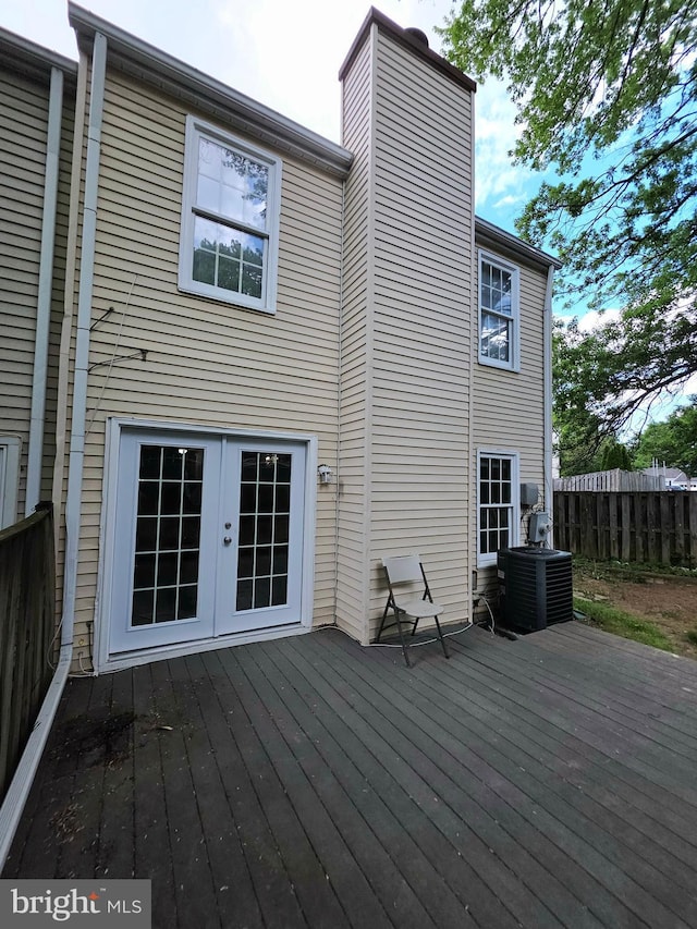 wooden terrace with fence, french doors, and cooling unit