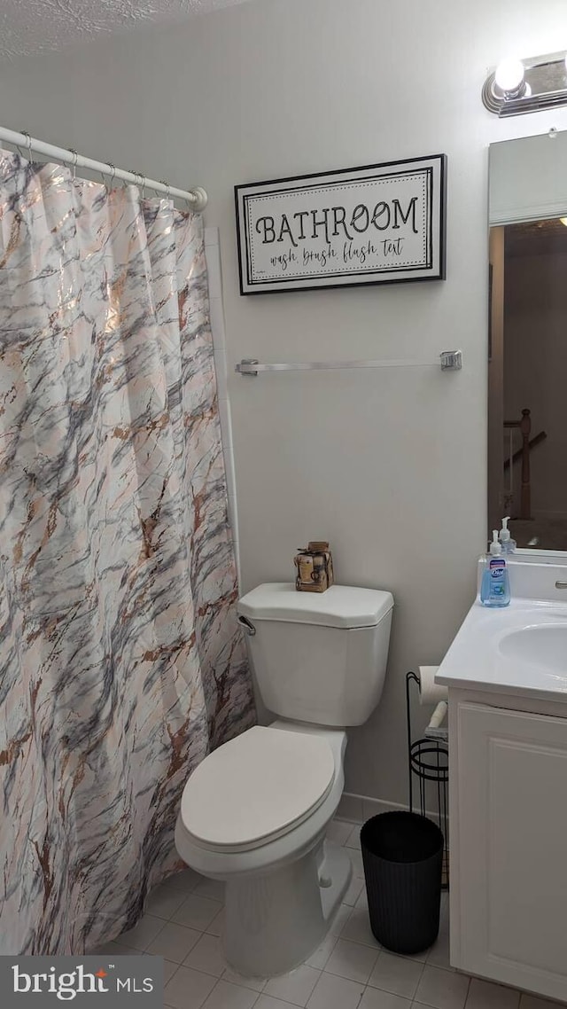 full bathroom featuring vanity, tile patterned floors, toilet, and a shower with curtain
