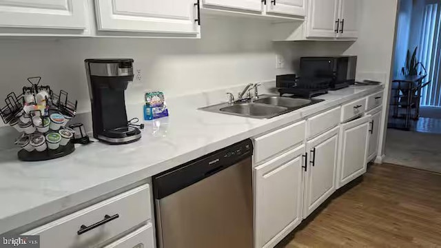 kitchen featuring a sink, light countertops, white cabinets, and dishwasher