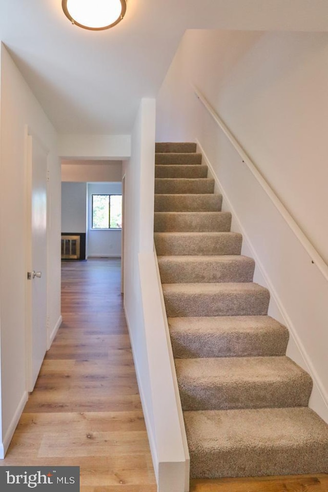 stairs featuring baseboards and wood finished floors