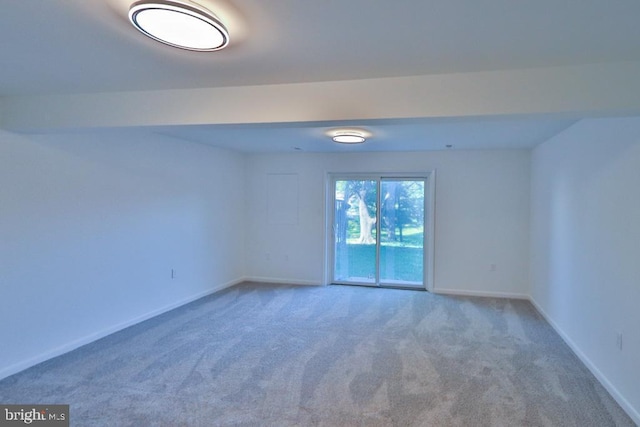 spare room with baseboards and carpet