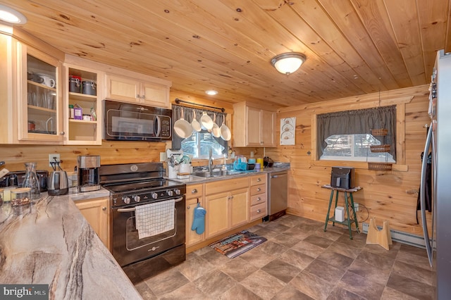 kitchen with a sink, light brown cabinetry, black appliances, and wooden ceiling