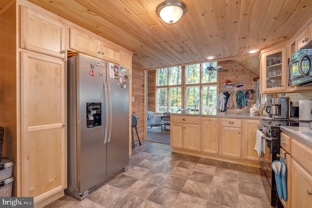 kitchen featuring wood walls, appliances with stainless steel finishes, light brown cabinetry, and wooden ceiling
