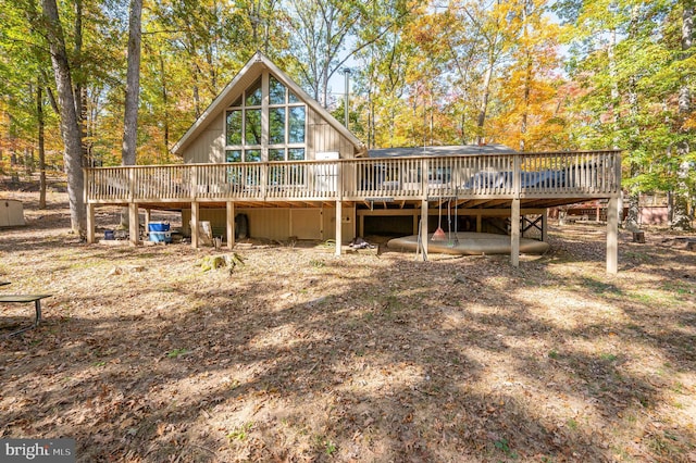 back of property with a wooden deck