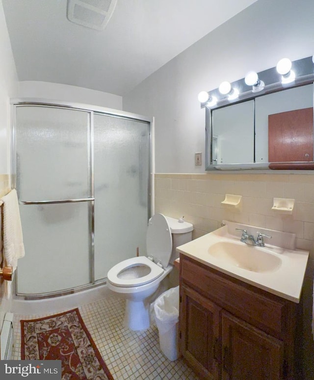 4564 Mountain Rd, Pasadena, MD 21122 - bathroom featuring vanity, tile walls, a shower stall, toilet, and wainscoting