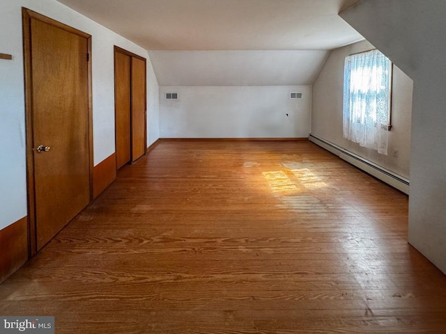 4564 Mountain Rd, Pasadena, MD 21122 - bonus room with a baseboard heating unit, vaulted ceiling, and wood finished floors