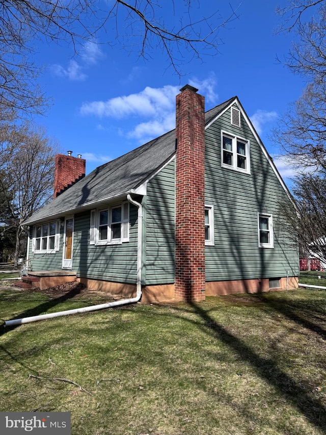4564 Mountain Rd, Pasadena, MD 21122 - view of side of home featuring a chimney and a yard
