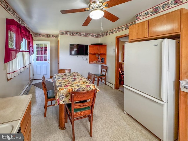 4564 Mountain Rd, Pasadena, MD 21122 - dining area featuring light floors, a ceiling fan, and a baseboard radiator