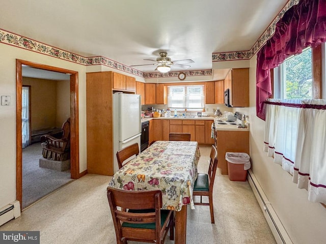 4564 Mountain Rd, Pasadena, MD 21122 - kitchen featuring a sink, freestanding refrigerator, light countertops, ceiling fan, and a baseboard heating unit