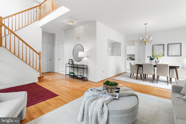 206 Cherrywood Ter, Gaithersburg, MD 20878 - living area with wood finished floors, stairs, and a chandelier