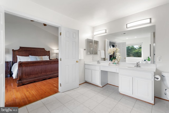 206 Cherrywood Ter, Gaithersburg, MD 20878 - full bathroom featuring double vanity, toilet, ensuite bathroom, and baseboards
