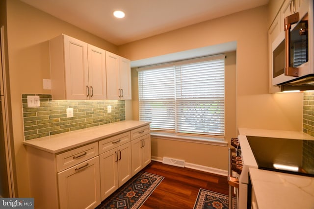 kitchen with visible vents, white cabinets, appliances with stainless steel finishes, and decorative backsplash