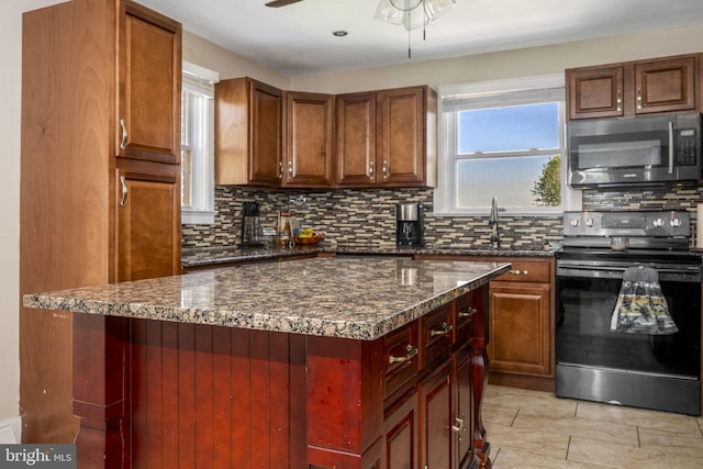326 Glasgow St, Pottstown, PA 19464 - kitchen with decorative backsplash, ceiling fan, electric range, stainless steel microwave, and dark stone countertops
