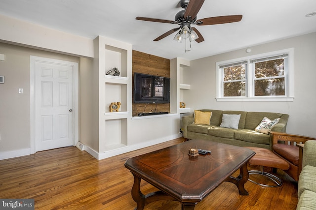 326 Glasgow St, Pottstown, PA 19464 - living room featuring baseboards, a ceiling fan, built in shelves, and wood finished floors