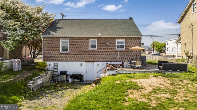 326 Glasgow St, Pottstown, PA 19464 - back of property featuring a patio, a shingled roof, fence, and brick siding