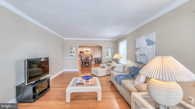 107 S Dover Ave, Atlantic City, NJ 08401 - living area with crown molding, arched walkways, wood finished floors, baseboards, and a notable chandelier