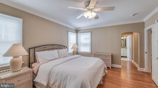 107 S Dover Ave, Atlantic City, NJ 08401 - bedroom featuring arched walkways, baseboards, ornamental molding, and light wood-style floors