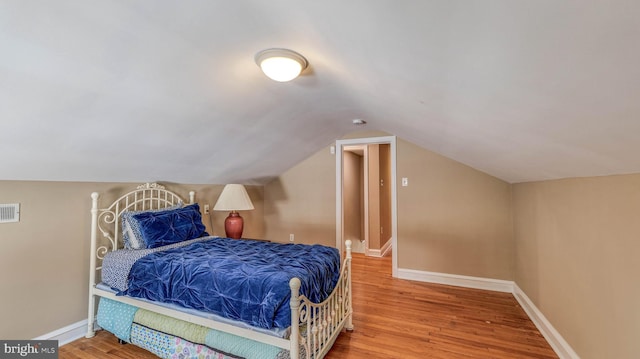107 S Dover Ave, Atlantic City, NJ 08401 - bedroom featuring visible vents, baseboards, wood finished floors, and vaulted ceiling