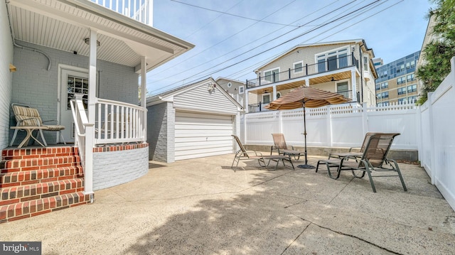 107 S Dover Ave, Atlantic City, NJ 08401 - view of patio with covered porch, fence, an outbuilding, and a garage