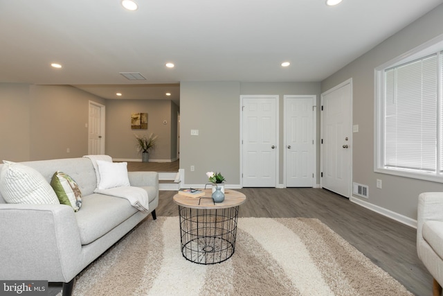 living room featuring baseboards, recessed lighting, wood finished floors, and visible vents