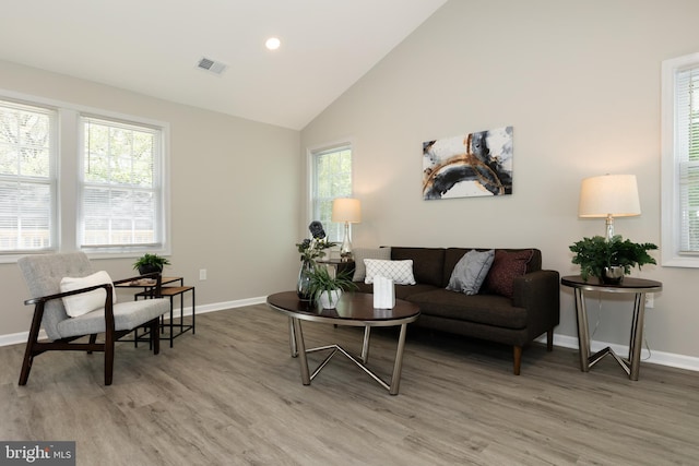 living room featuring baseboards, visible vents, and light wood-style floors