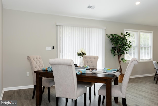 dining room featuring recessed lighting, baseboards, visible vents, and wood finished floors