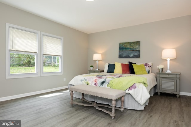 bedroom featuring baseboards and wood finished floors