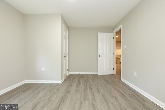 unfurnished bedroom featuring baseboards and wood finished floors