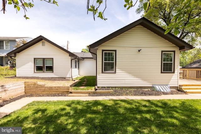 view of front of house with a wooden deck and a front yard