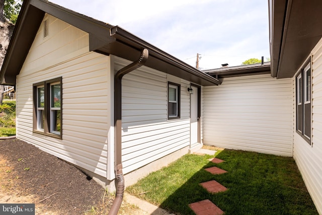 view of side of property with a lawn