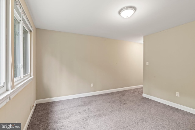 empty room with carpet floors and baseboards