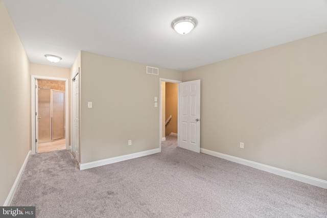 unfurnished bedroom featuring carpet floors and baseboards