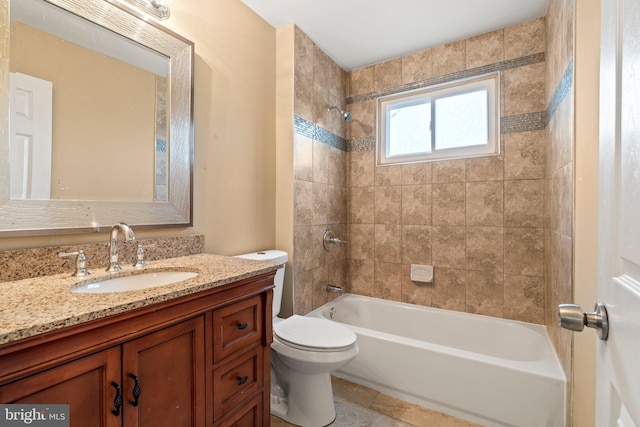 bathroom featuring toilet, vanity, and  shower combination