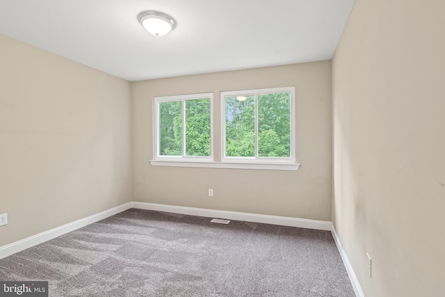 carpeted empty room with baseboards