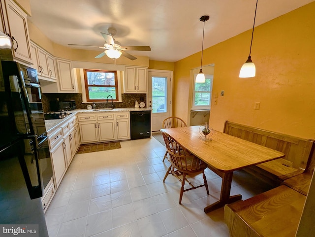 kitchen featuring black appliances, a wealth of natural light, tasteful backsplash, and a ceiling fan