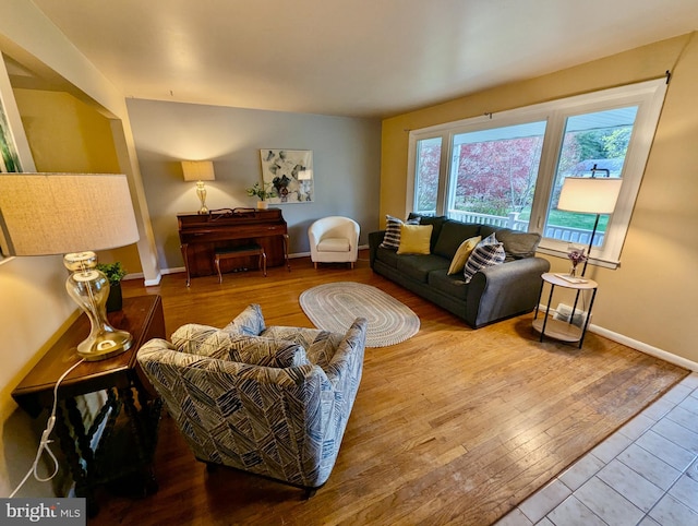 living area featuring wood finished floors and baseboards