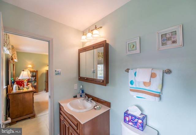 bathroom featuring toilet and vanity