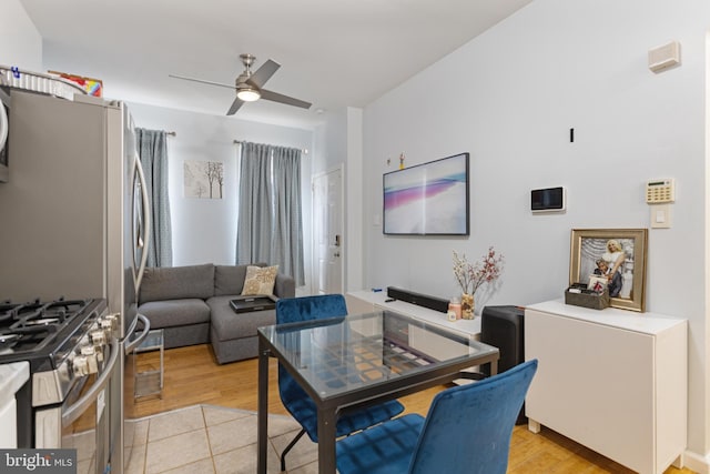 living area featuring a ceiling fan and light tile patterned floors