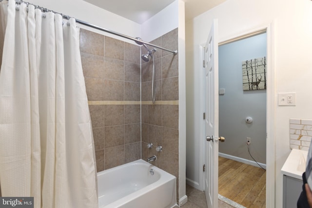 full bath with shower / bath combination with curtain, baseboards, and wood finished floors